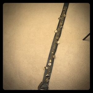 Belt with leather material and gold.